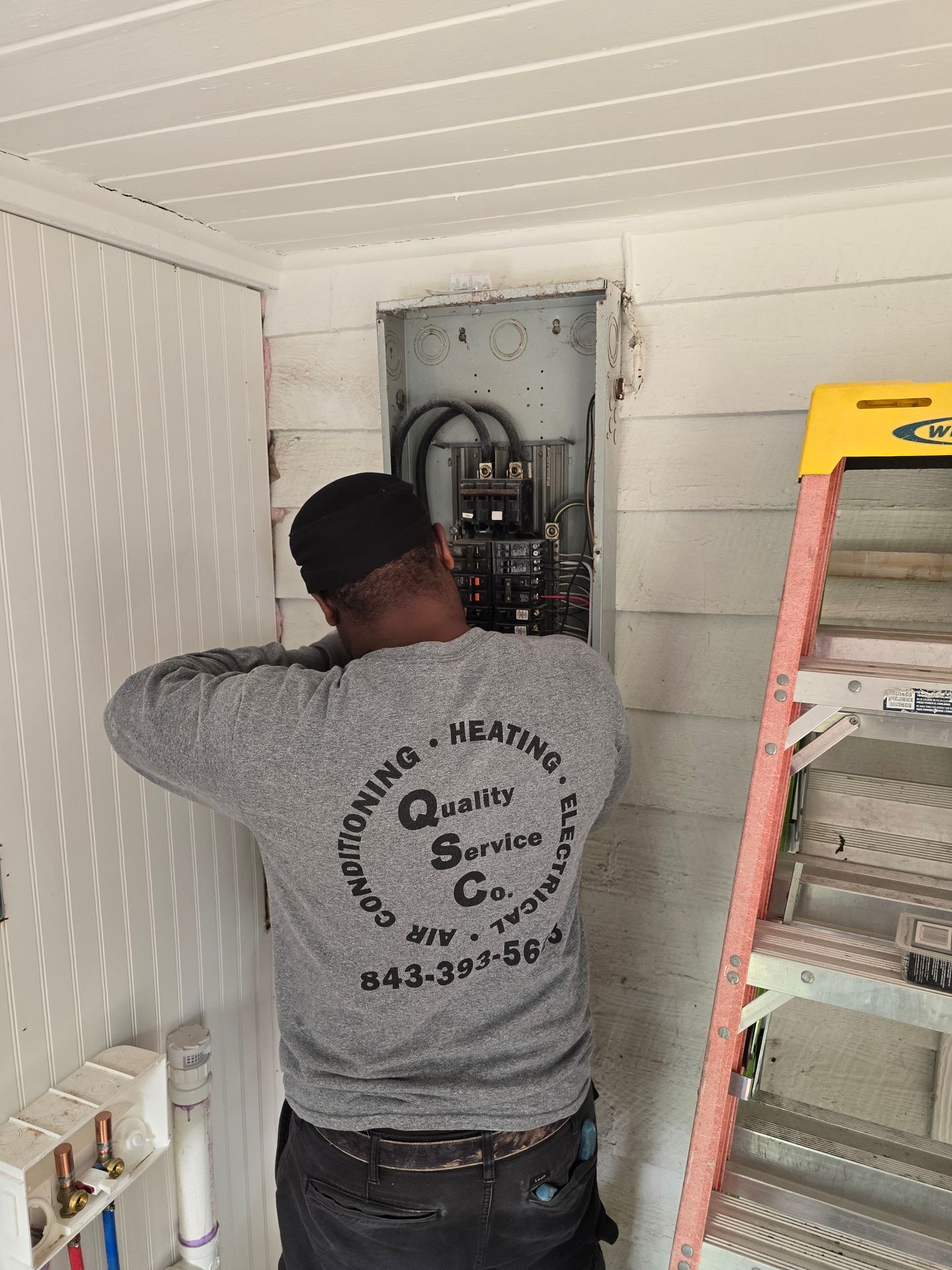 ELECTRICIAN  WORKING ON A PANEL BOX
