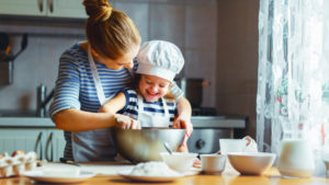 Mother and child baking in the kitchen together.