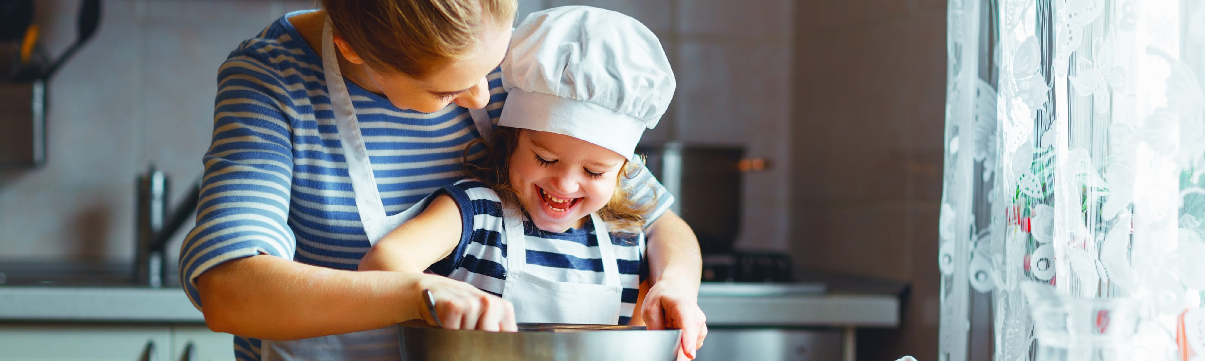 Mother and child baking in the kitchen together.