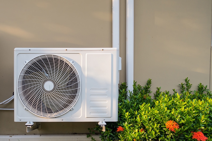 Air conditioning system installation embedded on wall of building.