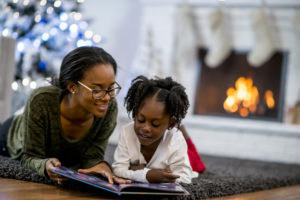 Mother and daughter relaxing in the winter after understanding the ways they can save money on their heating bill this winter.