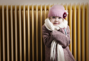 Little girl trying to stay warm while trying to figure out why her home's furnace isn't heating her entire home.