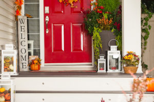 Fall HVAC Maintenance, red front door to home with front porch fall decorations