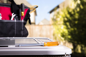 Screwdriver laying on top of an outdoor Ac unit