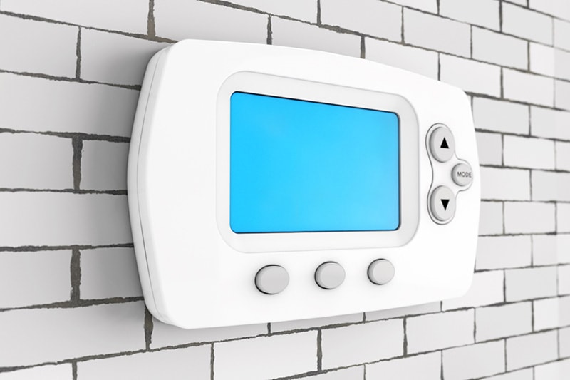 Blog Title: Why is My Thermostat Blank? Photo: Blank Thermostat on brick wall