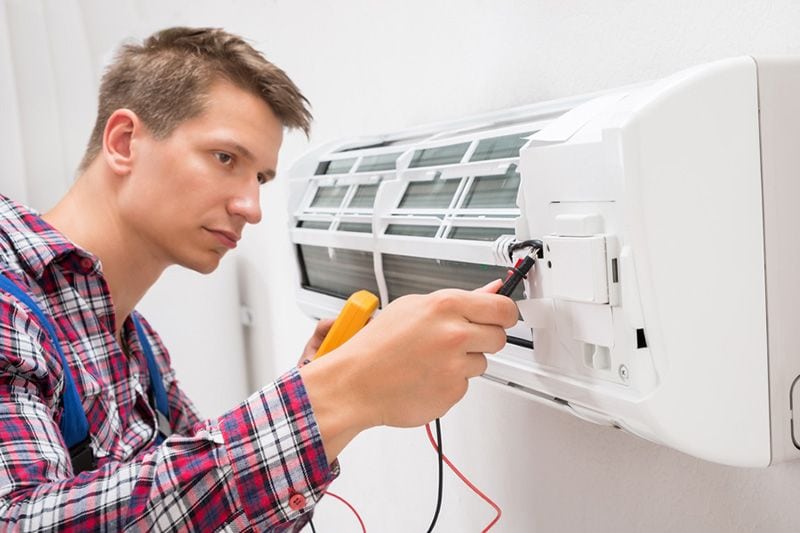 Image of someone working on a ductless system. What You Need to Know for an HVAC Emergency.