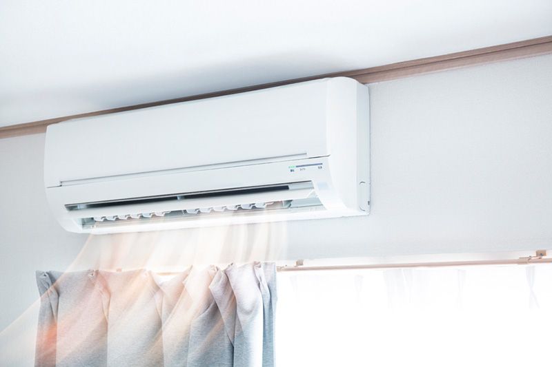 Planning to Remodel? Go Ductless! Image shows ductless AC unit mounted on home interior wall.