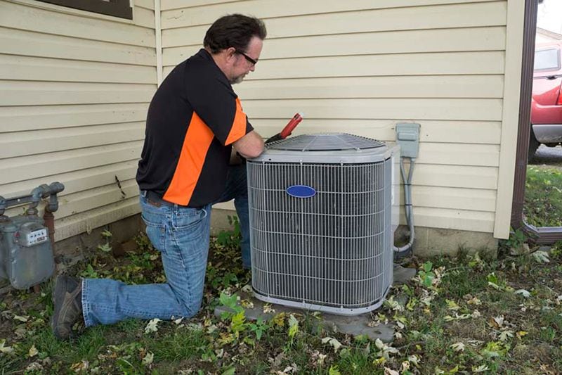 Image of HVAC technician working on AC. Do I Really Need an AC Tune-Up?